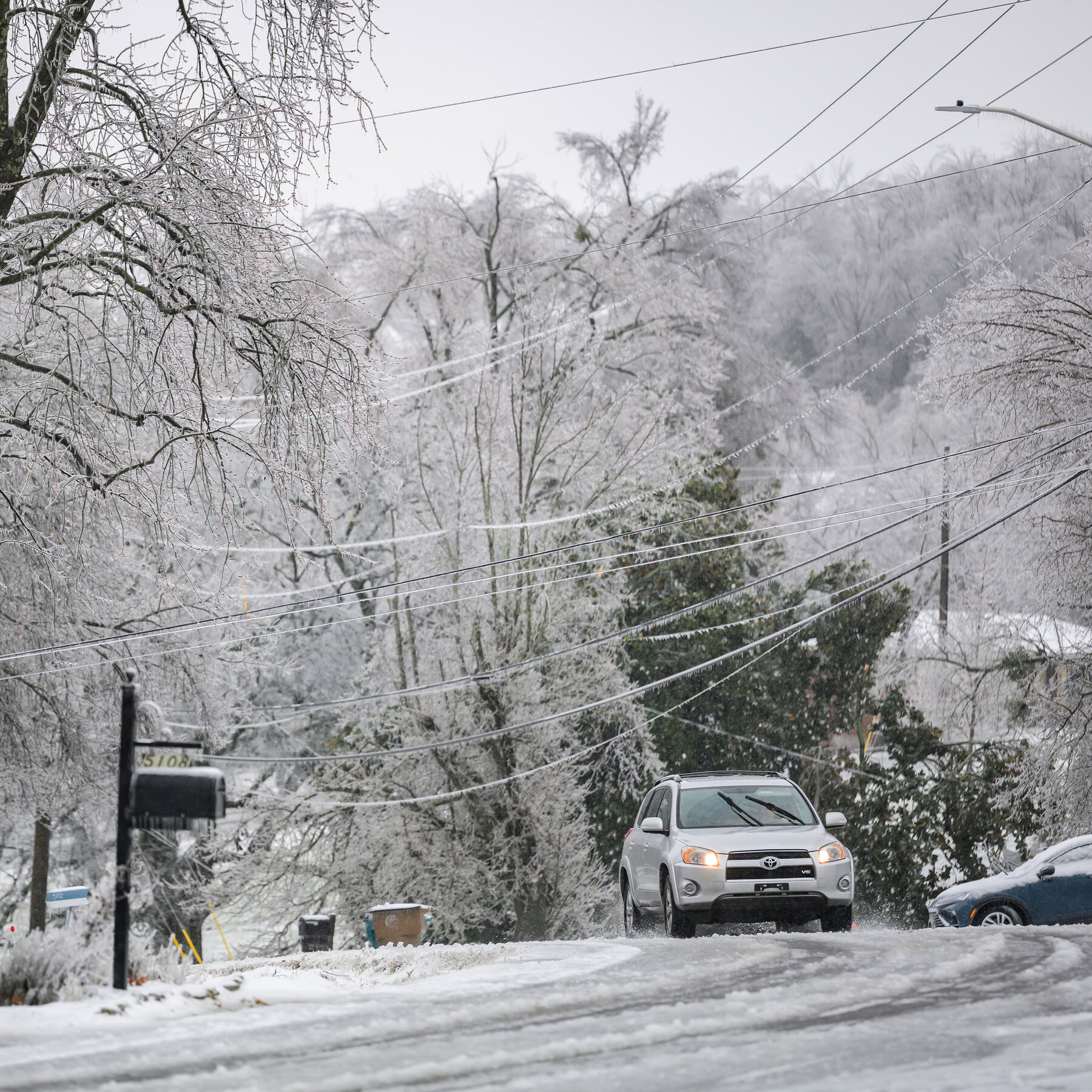 Branches and power lines come crashing down in Nashville under sheaths of ice.
